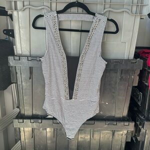 Buckle gimmicks. Mesh and stud bodysuit